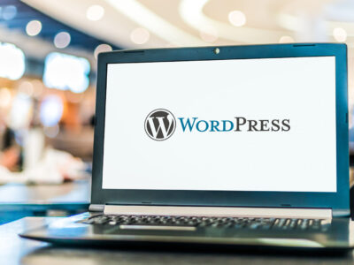 Laptop computer displaying logo of WordPress, a free and open-source content management system (CMS).