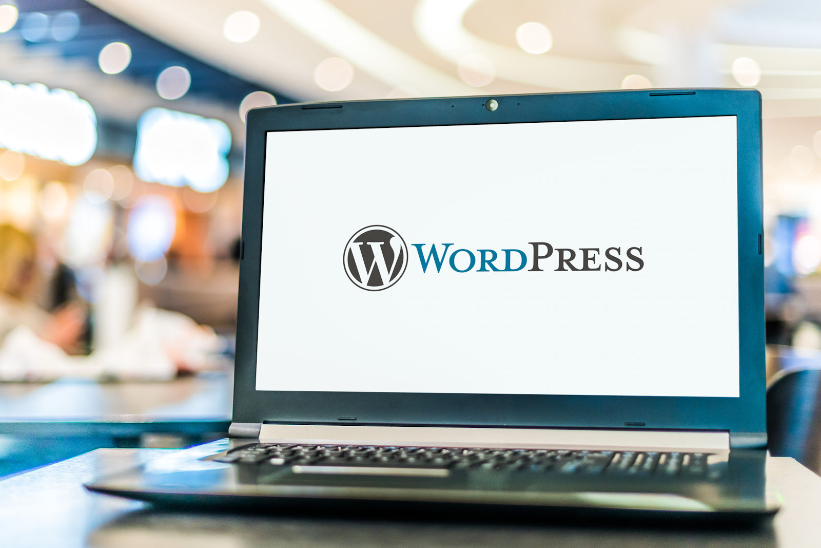 Laptop computer displaying logo of WordPress, a free and open-source content management system (CMS).