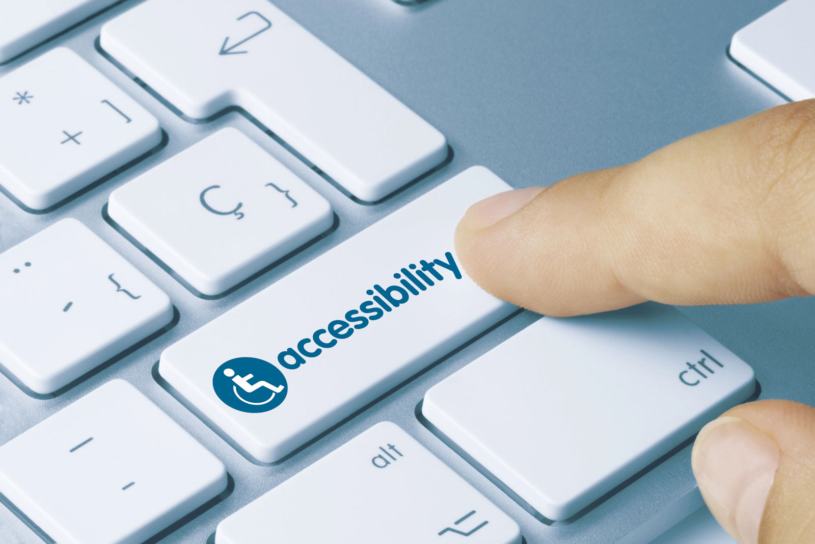 Finger clicking on accessibility button on computer keyboard