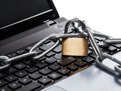 Padlock and chain on a laptop keyboard. Concept of internet security