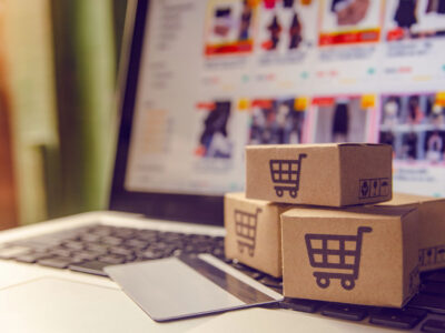 Shipping boxes sitting on the keyboard of a computer.