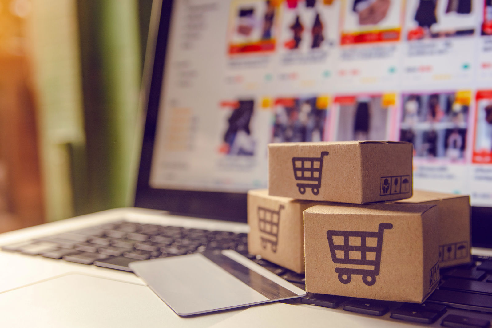 Shipping boxes sitting on the keyboard of a computer.