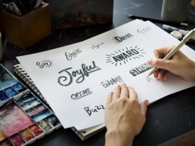 Artist drawing fonts for logos on paper